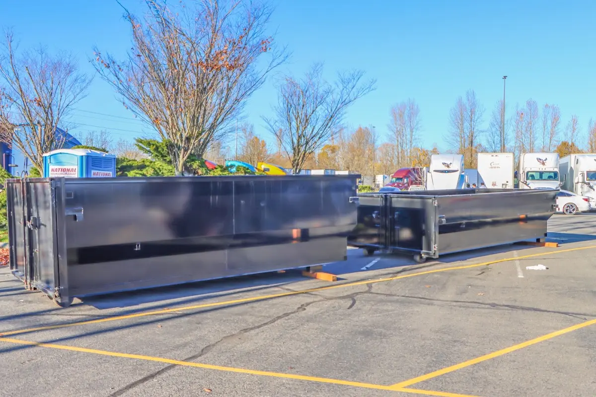 Professional dumpster rental service with roll-off container on residential driveway in Westville